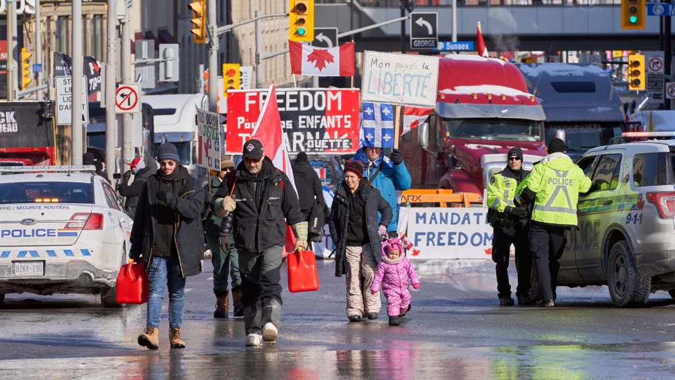 epa09736446 People bring gas tanks to truckers to continue their occupation near the Canadian parlement hill, after the mayor of Ottawa has declared a state of emergency in the Canadian capital after a 10-day-long protest by truck drivers over Covid-19 restrictions that has gridlocked its city center, in Ottawa, Canada, 07 February 2022. Truckers protested against the mandate by the Canadian government that truckers be vaccinated to return to Canada, and was joined by other opponents of the Canadian Prime Minister. Policemen from Ottawa city, Ontario, and the Federal Royal Canadian Mounted Police (RCMP) are deployed.  EPA/ANDRE PICHETTE