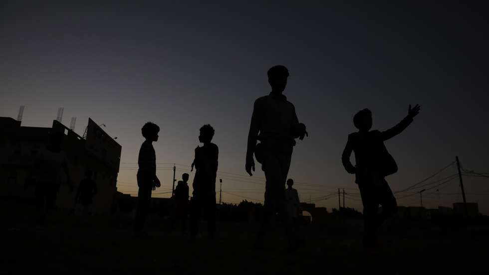epa10347262 The silhouette of young Yemenis playing soccer at a field of a neighborhood in Sana'a, Yemen, 03 December 2022. Soccer is one of the most popular sports in Yemen. The national football league has been suspended in the Houthis-controlled main cities, including the capital Sana'a, after the war erupted in March 2015, but football matches are being played by young people and children in neighborhoods.  EPA/YAHYA ARHAB
