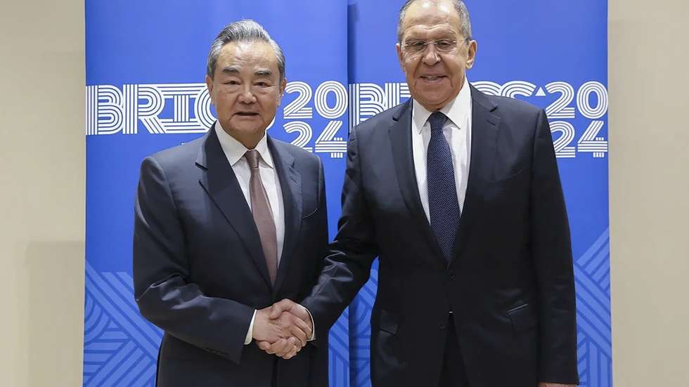 epa11401888 A handout photo made available by Russian Foreign ministry press service shows Russian Foreign Minister Sergey Lavrov (R) shaking hands with Chinese Foreign Minister Wang Yi on the sidelines of the meeting of BRICS foreign ministers in Nizhny Novgorod, Russia, 10 June 2024. This is the first meeting of foreign ministers after the expansion of BRICS in 2023. Now full members of the association are Brazil, Russia, India, China, South Africa, Egypt, Iran, the UAE, Saudi Arabia and Ethiopia.  EPA/RUSSIAN FOREIGN MINISTRY HANDOUT  HANDOUT EDITORIAL USE ONLY/NO SALES HANDOUT EDITORIAL USE ONLY/NO SALES