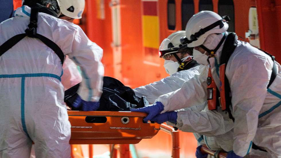 epa09063270 Members of the Maritime rescue services transfer the body of an immigrant at Arguineguin port in Gran Canaria, Spain, 09 March 2021. Five migrants died on board a toy boat that was rescued 250km south of the Canary Islands with a total of 49 people on board. Maritime rescue services were only able to rescue one body.  EPA/Angel Medina G.