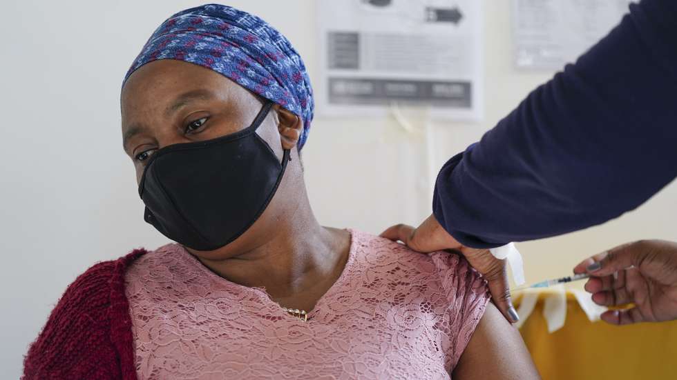 A woman receives a Pfizer Covid-19 Corona virus vaccination from a mobile team of health workers at the Masiphumelele Community Center, in Cape Town, South Africa, 07 September 2021. A mobile team of specialist health workers from the City of Cape Town in conjunction with various NGOs and government is moving around the province, targeting low coverage areas and areas that are far away from fixed vaccination centers in a bid to increase the rate of vaccination in South Africa. Local scientists are monitoring the C.1.2 variant as a variant of interest as it has spread across South Africa but has been detected at low frequency. To date, there are around 100 sequences of C.1.2 reported globally since the variant was first detected in South Africa in May this year