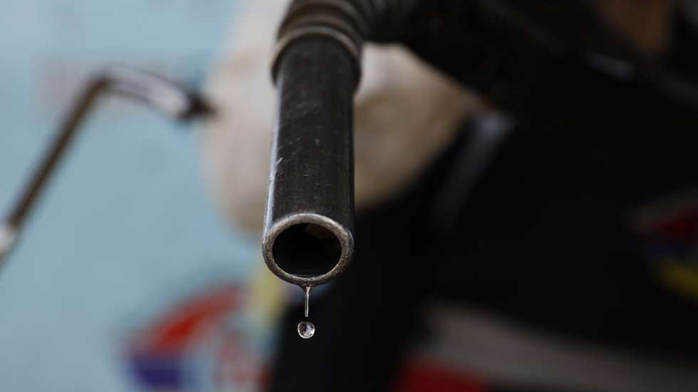 epa10251026 An attendant holds a fuel nozzle after pumping fuel into a vehicle at a gasoline station in Sana'a, Yemen, 18 October 2022. The Houthis-controlled petroleum authority has cut retail price of gasoline from 575 to 525 Yemeni rials per one litter (from one euro to 0.95 euro per one litter) in the northern Yemeni provinces under its control, in line with the global decline in oil prices as well as the flow of fuel imports into the Houthis-held ports.  EPA/YAHYA ARHAB