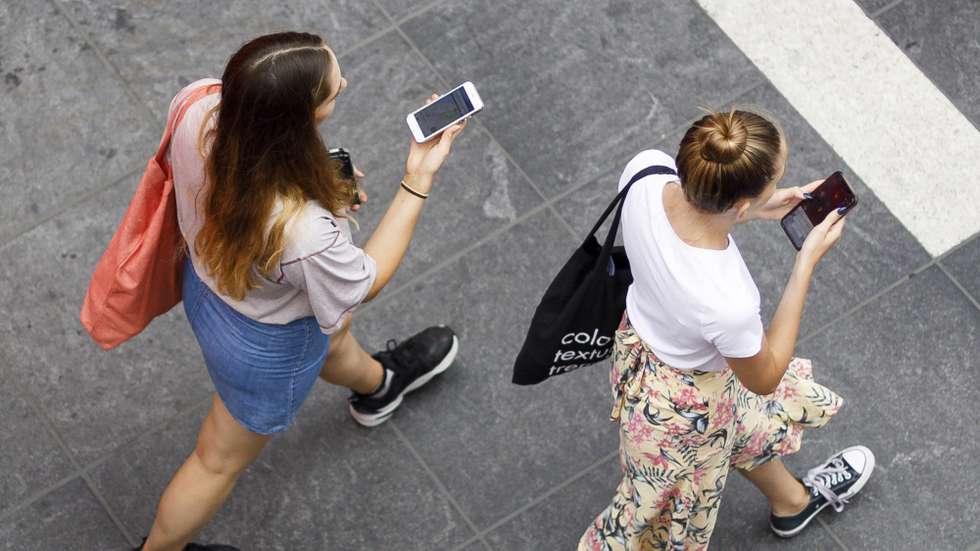 epa07735908 People look at their cell phones in New York, New York, USA, 23 July 2019. A bill being introduced on the same week by the New York City Council would make it illegal for cell phone companies and mobile data app developers from sharing customer's location information while in New York City.  EPA/JUSTIN LANE