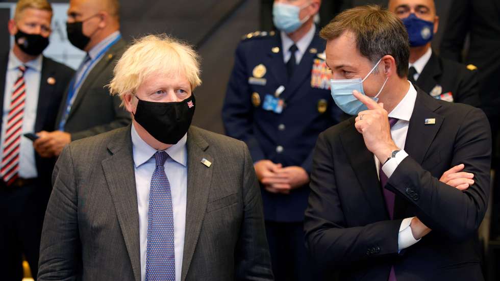 epa09270199 British Prime Minister Boris Johnson (L) speaks with Belgium's Prime Minister Alexander De Croo during a plenary session at a NATO summit in Brussels, Belgium, 14 June 2021. The 30-nation alliance hopes to reaffirm its unity and discuss increasingly tense relations with China and Russia, as the organization pulls its troops out after 18 years in Afghanistan.  EPA/OLIVIER MATTHYS / POOL
