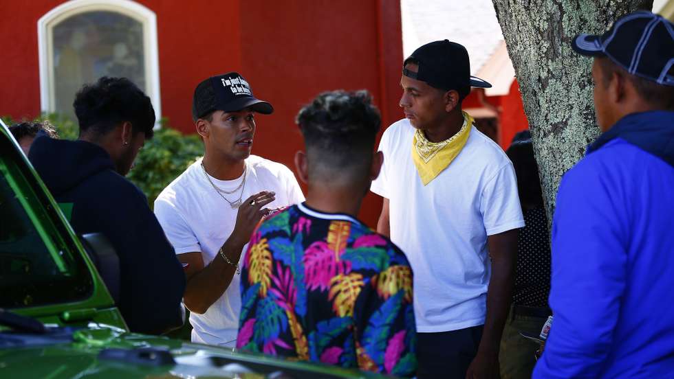 epa10186324 Members of a group of nearly 50 migrants from Venezuela who were flown to the island of Martha's Vineyard off Cape Cod, Massachusetts on 14 September speak outside the parish house at St. Andrew's Episcopal Church in Edgartown, Massachusetts, USA, 15 September 2022. Florida Governor Ron DeSantis took responsiblity for flying the migrants to Massachusetts, an unannounced move, during a media briefing on 15 September.  EPA/CJ GUNTHER