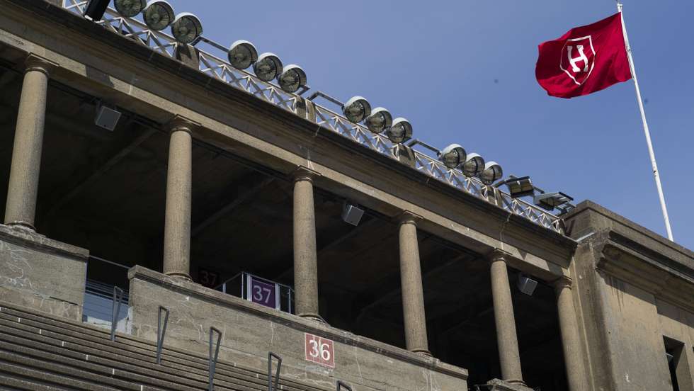 epa12006303 The Harvard flag flies over Harvard Stadium on the campus of Harvard University in Allston, Massachusetts, USA, 02 April 2025. The Department of Education announced on 30 March 2025 that there would be a comprehensive review of contracts and grants at Harvard University and its affiliates, as part of the Joint Task Force to Combat Anti-Semitism.  EPA/CJ GUNTHER