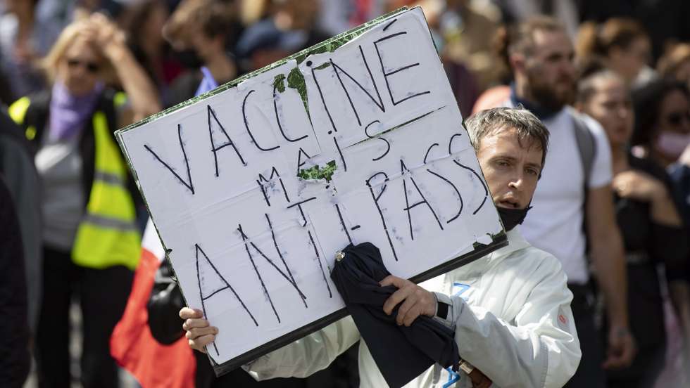 epa09404303 Protesters march during a demonstration against the COVID-19 health pass which grants vaccinated individuals greater ease of access to venues in France, in Paris, France, 07 August 2021. The national enforcement of the 'Health Pass' is expected to take effect on 09 August, after the French Constitutional Council has confirmed the government's law which extend the use of its Vaccinal Passeport (a QR code which proves the bearer has received full vaccination, or been tested negative for Covid in the last 72 hours) to cultural place, transport, and restaurants among other places.  EPA/IAN LANGSDON