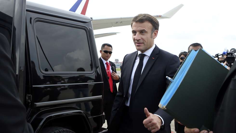 epa10305037 French President Emmanuel Macron reacts upon arriving at Ngurah Rai International Airport ahead of the G20 Summit in Bali, Indonesia, 14 November 2022. The 17th Group of Twenty (G20) Heads of State and Government Summit will be held in Bali from 15 to 16 November 2022.  EPA/FIRDIA LISNAWATI / POOL