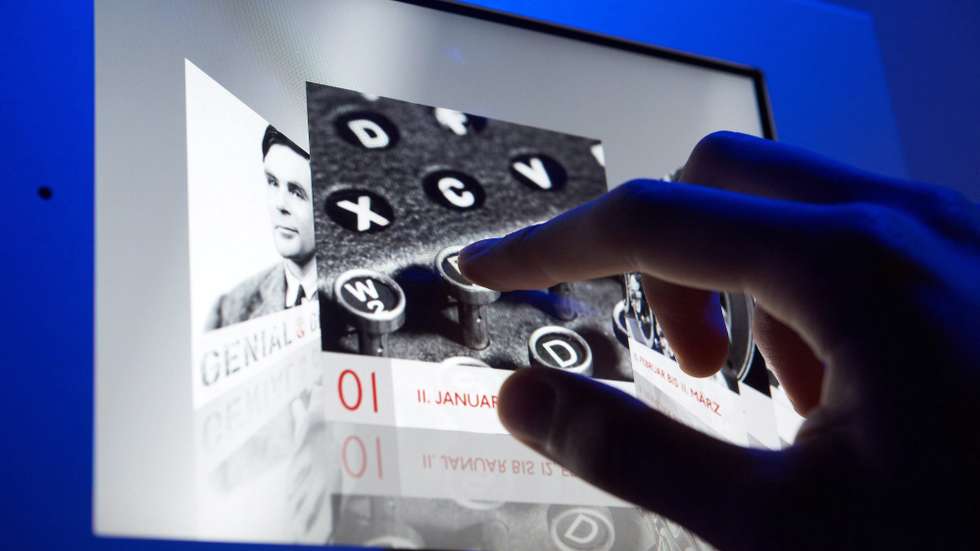 epa03055463 A museum employee uses an iPad attached to the wall while searching for information about the film program along the exhibition 'Eminent &amp; Enigmatic' at the Heinz Nixdorf Museumsforum (HNF) in Paderborn, Germany, 10 January 2012. The HNF is presenting the special exhibition 'Eminent &amp; Enigmatic - 10 aspects of Alan Turing' on the occassion of the 100th birthday of the British mathematician, computer pioneer and cryptologist Alan Turing in 10 consecutive exhibitions from 11 January until 16 December 2012. The first part of the exhibition deals with the decryption of the 'Enigma' machine by Turing during World War II.  EPA/BERND THISSEN