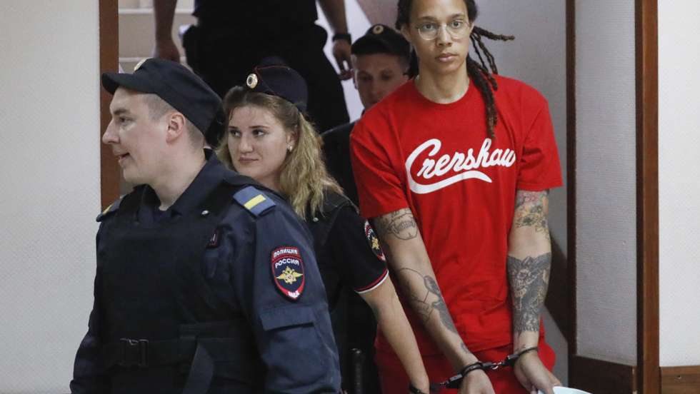 epa10056821 Two-time Olympic gold medalist and WNBA's Phoenix Mercury Brittney Griner (R) is escorted to a courtroom for a hearing, in Khimki City Court, outside Moscow, Russia, 07 July 2022. The Khimki City Court reportedly had extended Griner's detention for the duration of her trial on charges of drug smuggling that started on 01 July. Griner was arrested in February at Moscow's Sheremetyevo Airport after some hash oil was detected and found in her luggage, for which she now could face a prison sentence of up to ten years.  EPA/YURI KOCHETKOV
