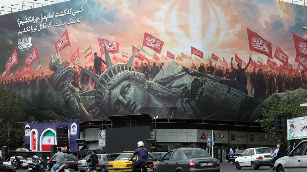epa13224596 Iranians drive past an anti-US billboard in Tehran, Iran, 09 September 2026. Iran’s Islamic Revolutionary Guard Corps (IRGC) claims to have captured a US military underwater drone at the entrance to the Strait of Hormuz as the conflict between Iran and the US continues as both sides trade fire.  EPA/ABEDIN TAHERKENAREH RESTRICTIONS: ISRAEL OUT- NO Access Israel Media/Persian Language TV Stations Outside Iran/Strictly No Access BBC Persian/VOA Persian/Manoto TV/Iran International TV. (As mandated by Iran's Directorate General for Foreign Media)