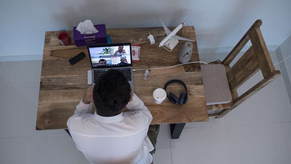 epa08321820 Mohamed Nader, 25, digital marketing manager, works from his home in Sharjah, United Arab Emirates, 24 March 2020. Most companies, including the Emirates federal government, are opting for teleworking to limit the spread of the covid-19 coronavirus.Nader says that 'the most negative thing about working at home is that you do not see people and communicate with people like drinking coffee with colleagues, But there are some positives points from home such as organizing work time and not wasting time in side conversations that have nothing to do with work'. EPA/Mahmoud KHALED ATTENTION: This Image is part of a PHOTO SET