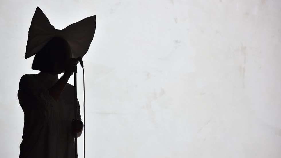 epa05469936 A picture made available on 10 August 2016 shows Australian singer-songwriter Sia performing on stage at the annual Byblos International Festival in the ancient city of Byblos, north of Beirut, Lebanon, 09 August 2016. The festival runs from 15 July to 09 August.  EPA/WAEL HAMZEH