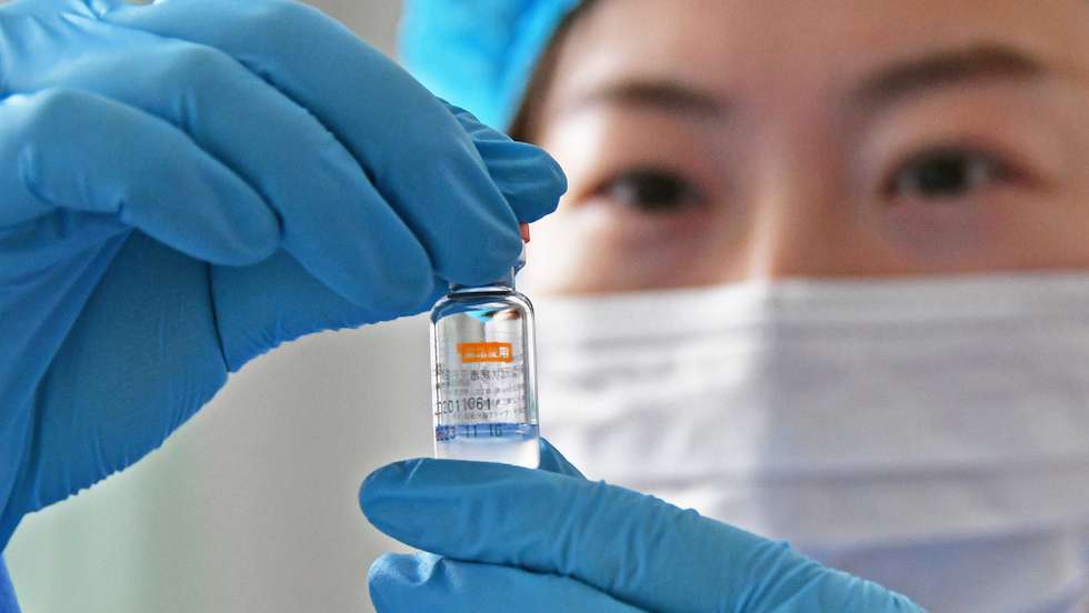 epa08921673 A medical worker checks a dose of Sinovac Biotech vaccine against the COVID-19 coronavirus disease at a community health station in Yantai, east China's Shandong province, 05 January 2021 (issued 06 January 2021). China plans to immunize 50 million people in certain high-risk groups before the Chinese Lunar New Year holidays in February, according to reports.  EPA/WEN TAN CHINA OUT