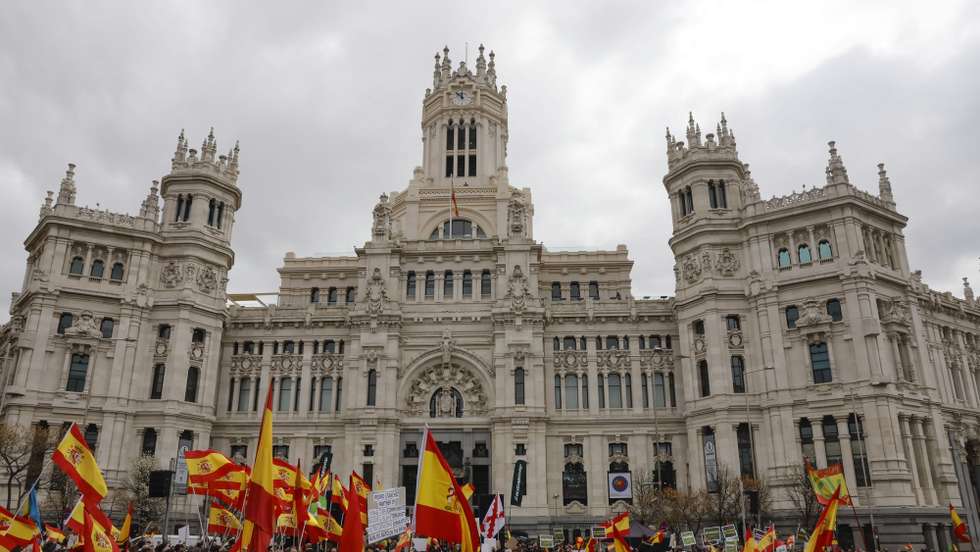 epa09835639 People hold Spanish flags during a demonstration called by Spanish right-far party Vox and Solidaridad union against the rise in prices of electricity, gasoline and basic supplies in Madrid, central Spain, 19 March 2022. About a thousand people, according to Spain's Central Government Delegation in Madrid staged a protest in Plaza de Cibeles in Madrid on 19 March to request the 'resignation' of Spanish Government and demand lower energy prices and fuels.  EPA/Ballesteros