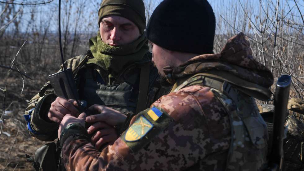 epa09845189 Ukrainian soldiers patrol the road near Kharkiv, Ukraine, 23 March 2022. On 24 February Russian troops had entered Ukrainian territory in what the Russian president declared a 'special military operation', resulting in fighting and destruction in the country, a huge flow of refugees, and multiple sanctions against Russia.  EPA/Andrzej Lange POLAND OUT