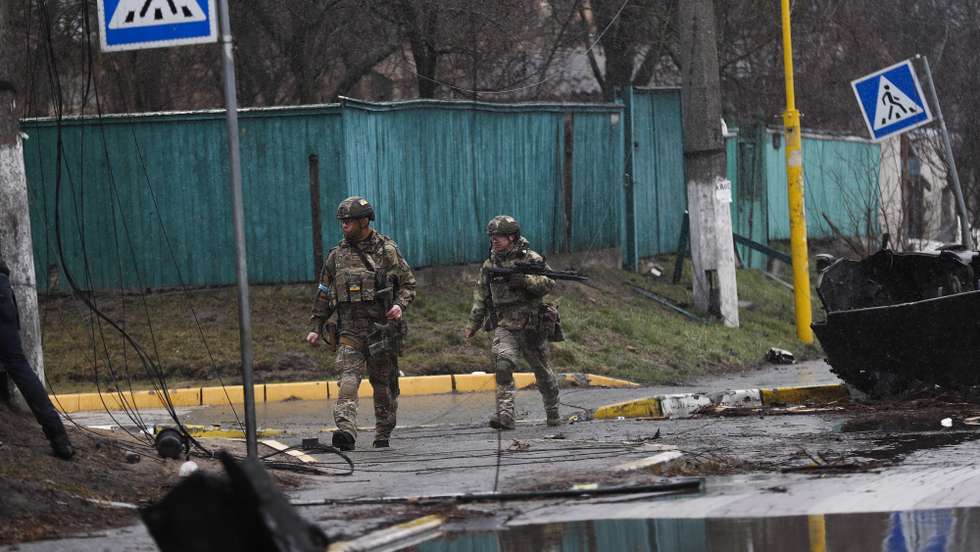 epa09868088 Ukrainian soldiers pass by a destroyed Russian military machinery in the areas recaptured by the Ukrainian army in the city of Bucha, Ukraine, 03 April 2022. Dmitrivka and the area around had recently been recaptured by the Ukrainian army from Russian forces. On 24 February, Russian troops had entered Ukrainian territory in what the Russian president declared a 'special military operation', resulting in fighting and destruction in the country, a huge flow of refugees, and multiple sanctions against Russia  EPA/ATEF SAFADI