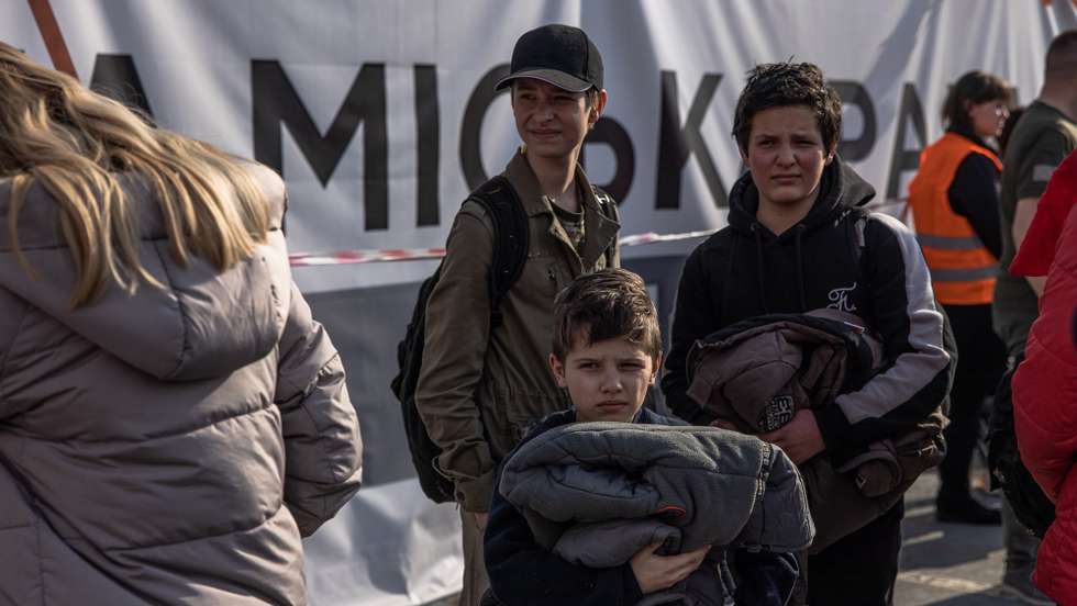 epa09924947 Slava (C) with his brother Volodymyr (R) who were evacuated from Mariupol’s steel plant Azovstal wait after arriving on a bus at the evacuation point in Zaporizhzhia, Ukraine, 03 May 2022. Around 100 civilians were evacuated from the steel plant, the last Ukrainian-controlled area in the southern port city of Mariupol, according to Ukrainian officials. Thousands of people who were still in Mariupol and other areas in South Ukraine occupied by the Russian army waited to be evacuated to Ukraine's controlled area by buses and their own cars.  EPA/ROMAN PILIPEY