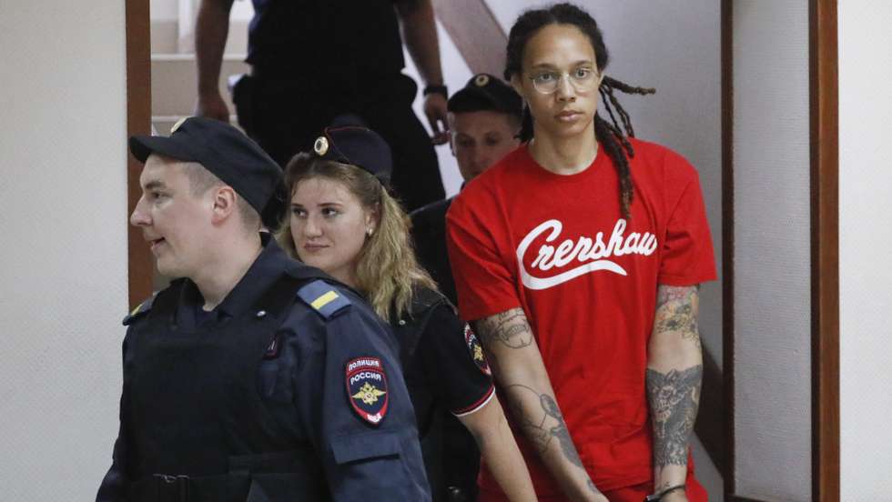 epa10056821 Two-time Olympic gold medalist and WNBA's Phoenix Mercury Brittney Griner (R) is escorted to a courtroom for a hearing, in Khimki City Court, outside Moscow, Russia, 07 July 2022. The Khimki City Court reportedly had extended Griner's detention for the duration of her trial on charges of drug smuggling that started on 01 July. Griner was arrested in February at Moscow's Sheremetyevo Airport after some hash oil was detected and found in her luggage, for which she now could face a prison sentence of up to ten years.  EPA/YURI KOCHETKOV