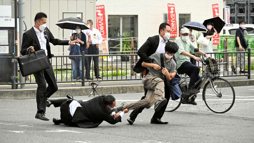 epa10058891 Security police tackle a suspect who is believed to have shot former Prime Minister Shinzo Abe outside Yamato-Saidaiji  Station in Nara, Japan, 08 July 2022. The suspect identified as Tetsuya Yamagami was arrested and taken into custody. According to Japan's national broadcaster, former Prime Minister Shinzo Abe died of his injuries on 08 July 2022, hours after being shot during an Upper House election campaign act to support a party candidate, outside Yamato-Saidaiji railway station in Nara, western Japan.  EPA/The Asahi Shimbun - JAPAN OUT - EDITORIAL USE ONLY FOR ONE MONTH until 08 August 2022 -  EDITORIAL USE ONLY