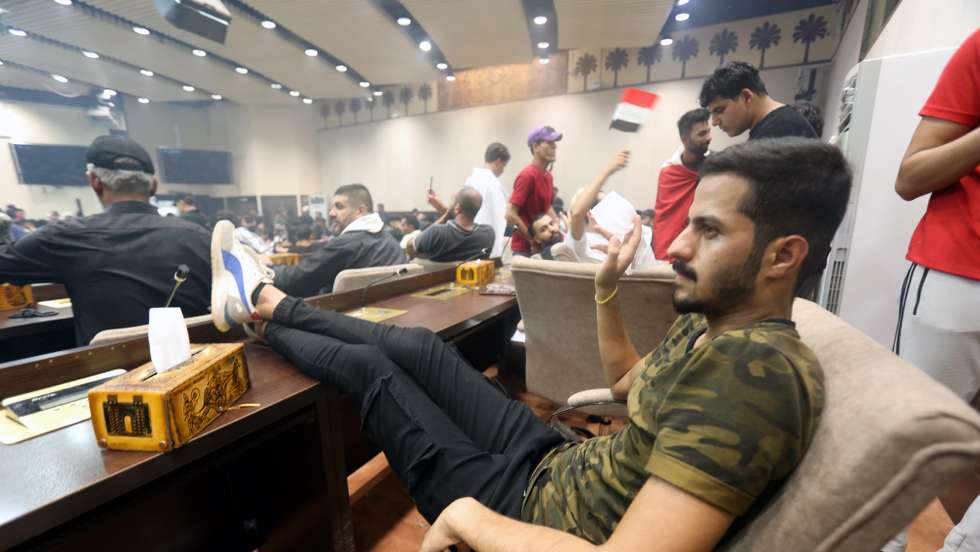 epa10098837 Supporters of Iraqi Shiite cleric Muqtada al-Sadr, head of the Sadrist movement, gather inside the Iraqi parliament hall after they stormed the 'Green Zone' in central Baghdad, Iraq, 30 July 2022. Thousands of supporters of the Shiite cleric Muqtada al-Sadr breached the heavily fortified Green Zone, home to government buildings and foreign embassies in Baghdad, for the second time in three days, protesting against a premiership candidate announced by the Shiite Coordination Framework earlier this week. Al-Sadr called on his supporters to sit in inside the Iraqi parliament building.  EPA/AHMED JALIL