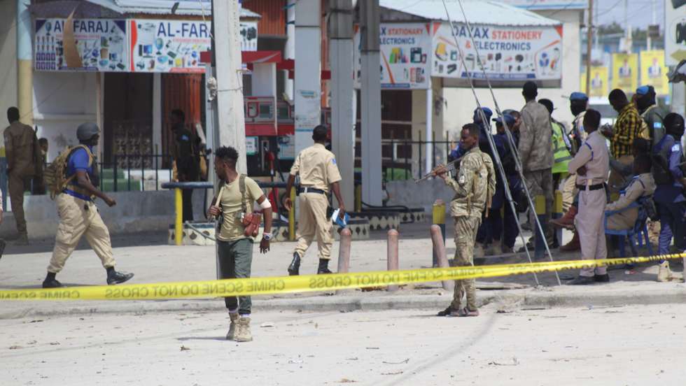 epa10130094 Somali security officials gather at the cordoned-off scene of an attack, outside the Hayat Hotel in Mogadishu, Somalia, 20 August 2022. According to Somaliaâ€™s security officials, at least 10 people were killed in the attack reportedly carried out by al-Shabab militants on 19 August. The attack involved explosions outside the hotel and gunfire.  EPA/SAID YUSUF WARSAME