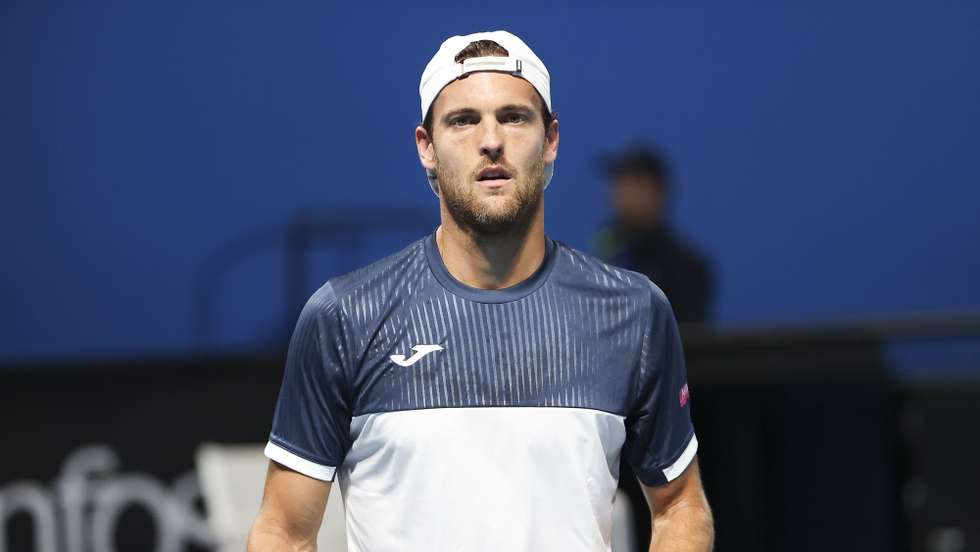 epa10410999 Joao Sousa of Portugal in action against Roberto Bautista Agut of Spain  during their first round match at the Australian Open tennis tournament in Melbourne, Australia 17 January 2023.  EPA/FAZRY ISMAIL