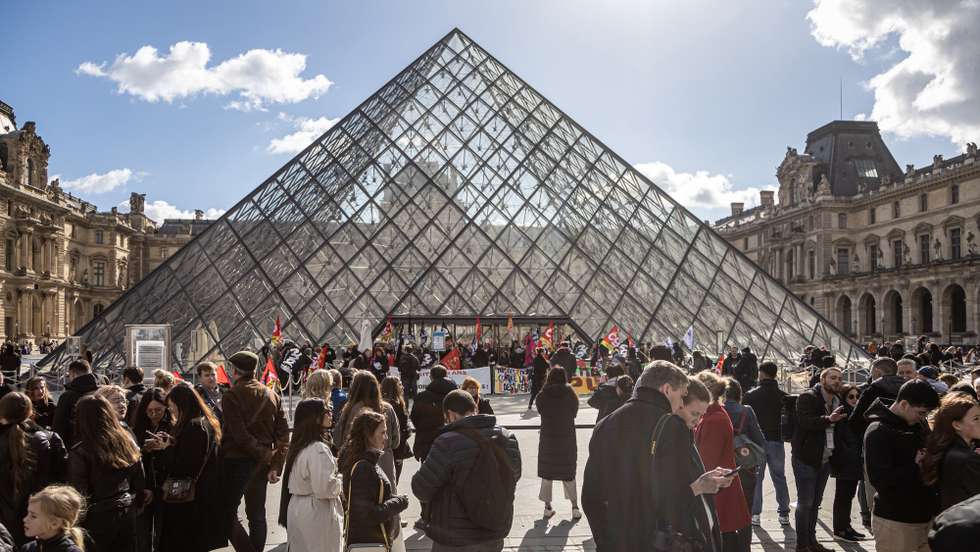 epa10545202 Visitors wait outside the Louvre Museum as its employees block entrance during a demonstration to protest against the government's pension reform in Paris, France, 27 March 2023. France faces an ongoing national strike against the government's pensions reform after Prime Minister Elisabeth Borne on 16 March announced the use of article 49 paragraph 3 (49.3) of the Constitution of France to have the text on the controversial pension reform law to be definitively adopted without a vote.  EPA/CHRISTOPHE PETIT TESSON