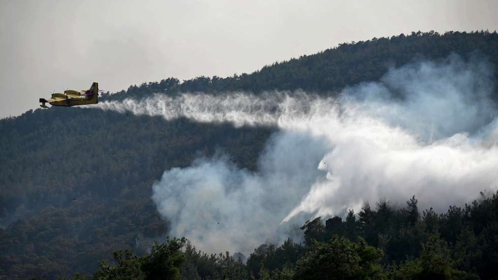epa10818408 A firefighting aircraft operates during a wildfire at Dadia forest, Thrace, northern Greece, 24 August 2023. Greek and foreign firefighters and volunteers, along with land and air assistance, battled for a sixth day to contain and put out the large fire in the natural habitat of the Dadia Forest. The forest has suffered extensive damage and it is feared that Black Vultures (Aegypius monachus) that live in the forest along with another 35 species of birds of prey will be greatly affected. The smoke that has covered the area has made assessment of the damage impossible. Albanian firefighters who arrived with five fire trucks relieved their colleagues from Romania, while firefighters from the Czech Republic surveyed the area to organize their operations in the coming days.  EPA/DIMITRIS ALEXOUDIS