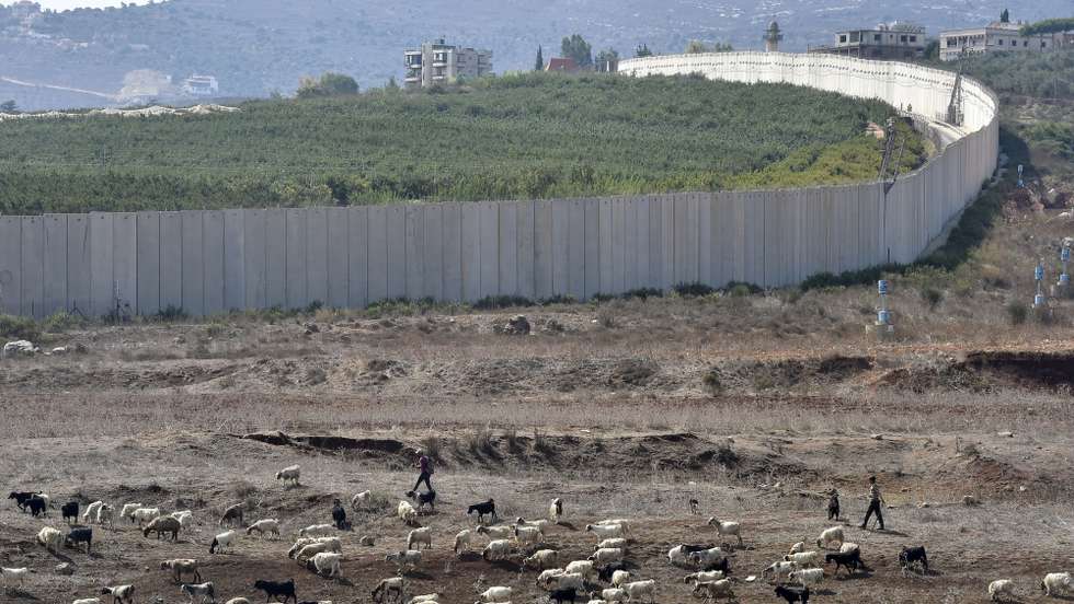 epa10909508 Lebanese shepherds herd goats near the Blue Line and the wall separating Israel and Lebanon, seen from the town of Kafarkila, southern Lebanon, 09 October 2023. More than 700 Israelis were killed and over 2,000 were injured since the Islamist movement Hamas carried out an unprecedented attack on southern Israel on 07 October, the Israeli army said. According to Palestinian officials, more than 500 people were killed and nearly 3,000 were injured as a result of Israelâ€™s retaliatory raids and air strikes in the Palestinian enclave.  EPA/WAEL HAMZEH