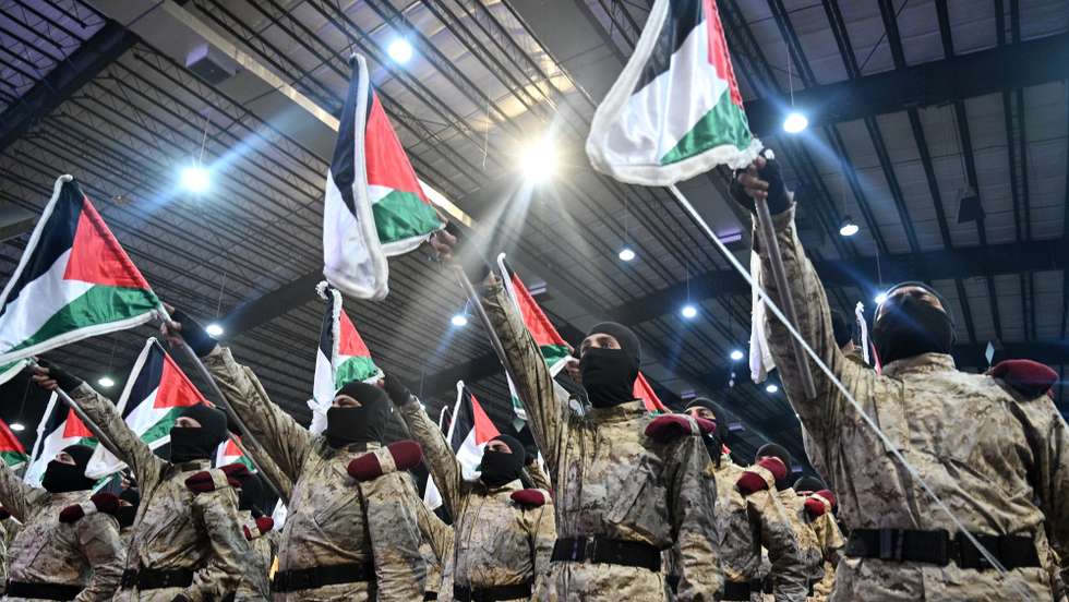 epa11260780 Hezbollah members stand in formation and hold up Palestinian flags during a gathering to commemorate Al Quds Day (Jerusalem Day) in a suburb of Beirut, Lebanon, 05 April 2024. Al Quds Day was declared in 1979 by the late Ayatollah Khomeini, founder of the Islamic Iranian Republic, who called on the world's Muslims to show solidarity with Palestinians on the last Friday of the fasting month of Ramadan.  EPA/WAEL HAMZEH