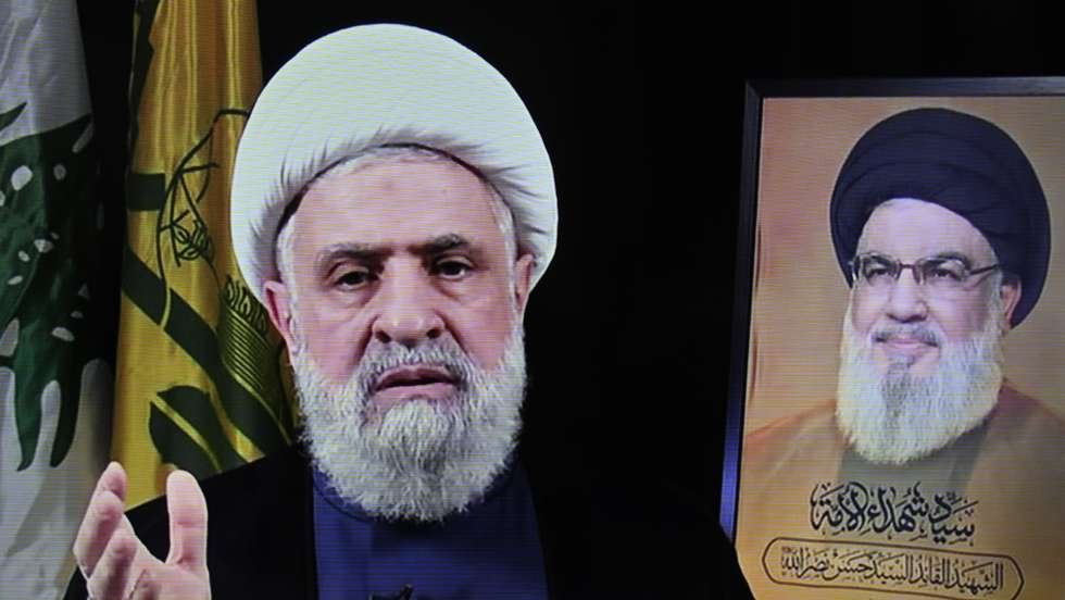 epa11692456 A photo of a screen shows Hezbollah's new leader Sheikh Naim Qassem (L) delivering a televised speech broadcasted on Hezbollah's al-Manar TV channel, in Beirut, Lebanon, 30 October 2024. Lebanon's Hezbollah on 29 October announced that its deputy leader Naim Qassem was appointed to succeed late chief Hassan Nasrallah (R).  EPA/WAEL HAMZEH