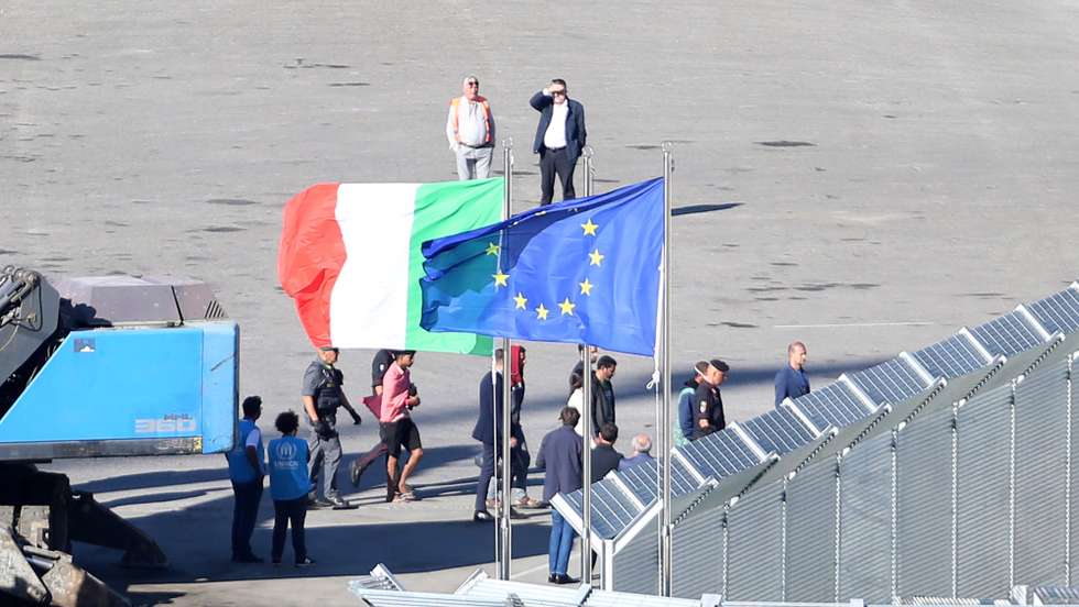 epaselect epa11661890 A group of migrants intercepted in Italian waters arrive aboard an Italian navy boat at Shengjin, Albania, 16 October 2024. Italy has begun sending migrants rescued in the Mediterranean to detention centers in Albania, where their asylum claims will be processed. The plan, finalized in February 2024, allows Italy to transfer up to 36,000 asylum seekers to Albania annually, with the goal of deterring migrants from attempting to reach Italy. While the Italian government and some EU leaders support the program, human rights groups criticize it for potentially putting migrants at risk and exposing them to rights violations.  EPA/MALTON DIBRA