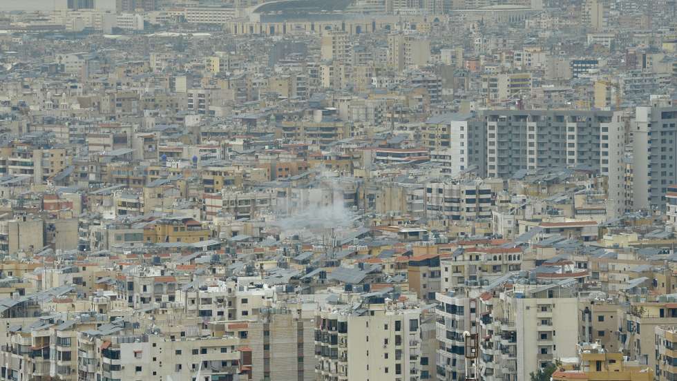 epa11994428 Smoke is seen billowing over buildings in Dahieh, southern Beirut, Lebanon, 28 March 2025. According to Lebanese official media, the airstrike followed an Israeli military warning earlier on 28 March.  EPA/WAEL HAMZEH