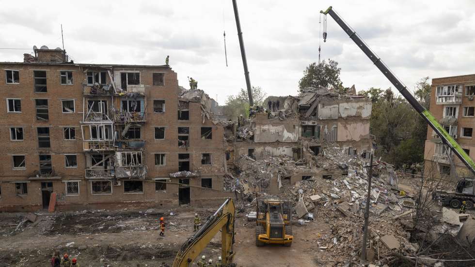 epa13287580 Ukrainian rescuers work at the site of a Russian attack on a residential building in Pryluky, Chernihiv area, Ukraine, 07 October 2026. According to the State Emergency Service of Ukraine report, at least nine people, including three children, were killed and 40 others injured after a Russian missile hit the apartment complex, as search-and-rescue teams continue clearing rubble to locate missing residents.  EPA/SERHII OKUNEV