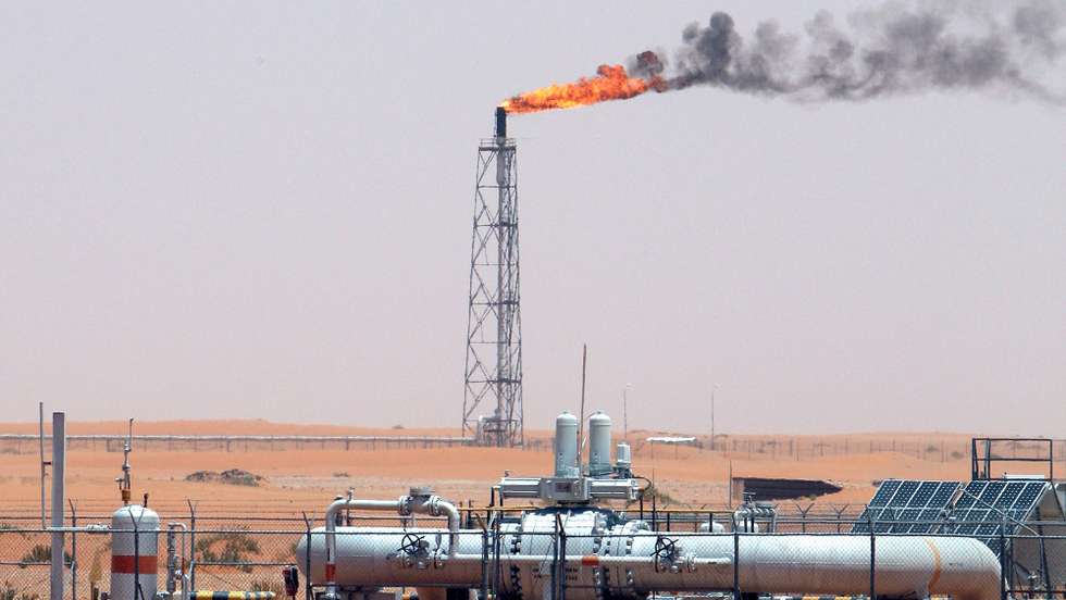epa09087338 (FILE) - A gas flame behind pipelines in the desert at Khurais oil field, about 160 km from Riyadh, Kingdom of Saudi Arabia, 23 June 2008 (reissued 21 March 2021). Energy giant Saudi Aramco, the world's biggest oil company, says that its profits sharply fell in 2020 to 49 billion USD down from 88.2 billion USD in 2019 and 111.1 billion USD in 2018.The sharp dive came as the coronavirus pandemic hit global energy markets.  EPA/ALI HAIDER *** Local Caption *** 55598188