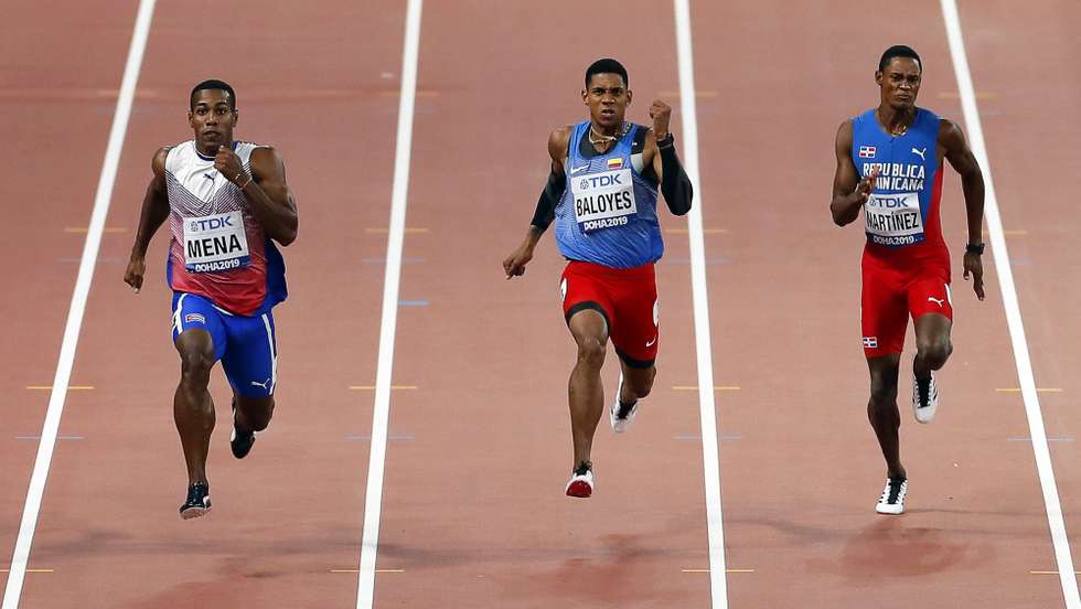 epa07880406 (L-R) Reynier Mena of Cuba, Bernardo Baloyes of Colombia, and Yancarlos Martinez of the Dominican Republic in action during the men's 200m heats at the IAAF World Athletics Championships 2019 at the Khalifa Stadium in Doha, Qatar, 29 September 2019. EPA/VALDRIN XHEMAJ
