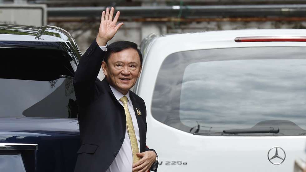 epa12316331 Former Thai Prime Minister Thaksin Shinawatra waves after arriving at the Criminal Court to hear the court's decision on charges of insulting the monarchy, in Bangkok, Thailand, 22 August 2025. Thailand's Criminal Court on 22 August acquitted former Thai PM Thaksin Shinawatra of violating the Lese-majeste Law and the Computer Crime for allegedly defaming the monarchy in comments made during an interview with a South Korean newspaper in May 2015. The verdict was reached because the plaintiff could not prove whether the clip was edited or not, and the defendant's words did not specifically mention the institution.  EPA/NARONG SANGNAK