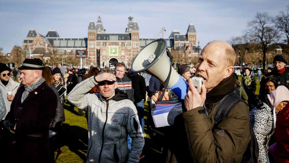epa08977628 Protesters on the Museumplein at Museumplein, Amsterdam, Netherlands, 31 January 2021. According to media reports, Museumplein, is once again, classified as a 'security risk area', giving police officers the right to check and search anybody in that area without a cause. The police are extra vigilant about demonstrations and riots on Museumplein, after things got out of hand a week earlier.  EPA/ANP09