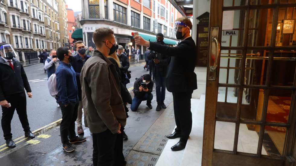 epa09207556 Theater-goers get their temparature check as they arrive to St Martins theatre in London, Britain, 17 May 2021. Britain is easing some coronavirus restrictions allowing indoor locations such as pubs, museums, galleries, cinemas, and adult group sports and exercise classes to reopen from 17 May. Also, legal restrictions on meeting others outdoors are lifted. British Prime Minister Johnson hopes to be able to lift the majority of COVID-19 rules by 21 June.  EPA/VICKIE FLORES