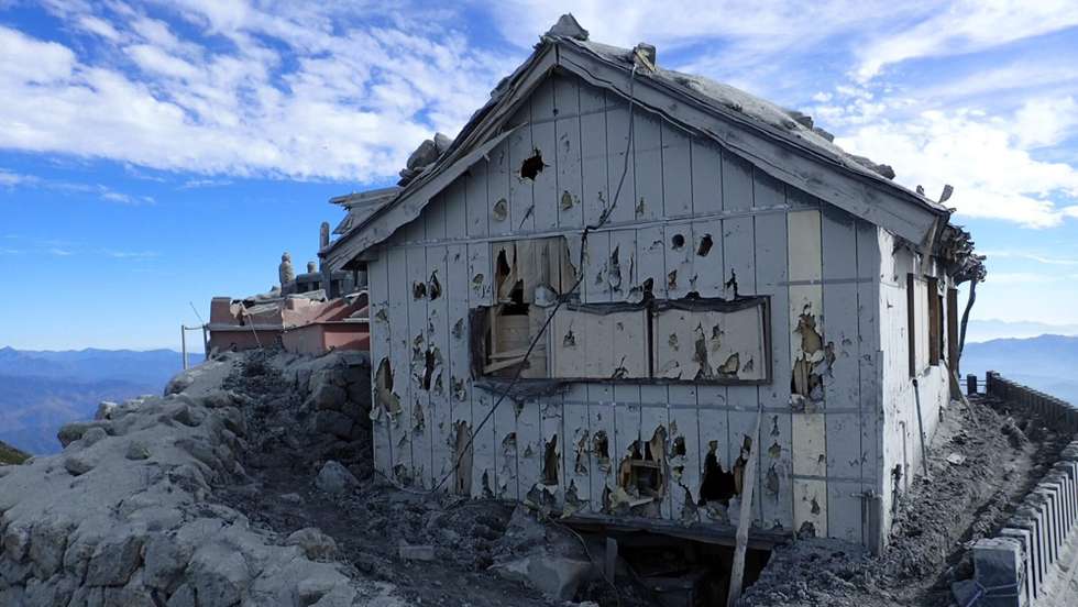 epa04442824 A handout picture taken and released on 12 October 2014 by Japan's Defense Ministry Joint Staff shows a damage construction at the summit of the Mount Ontake, between Gifu and Nagano prefectures, in central Japan. JGSDF personnel, firefighters and police forces continue their search on Mount Ontake as latest reports say that 56 people were killed by the 27 September eruption.  EPA/JAPAN'S DEFENSE MINISTRY JOINT STAFF / HANDOUT  HANDOUT EDITORIAL USE ONLY/NO SALES