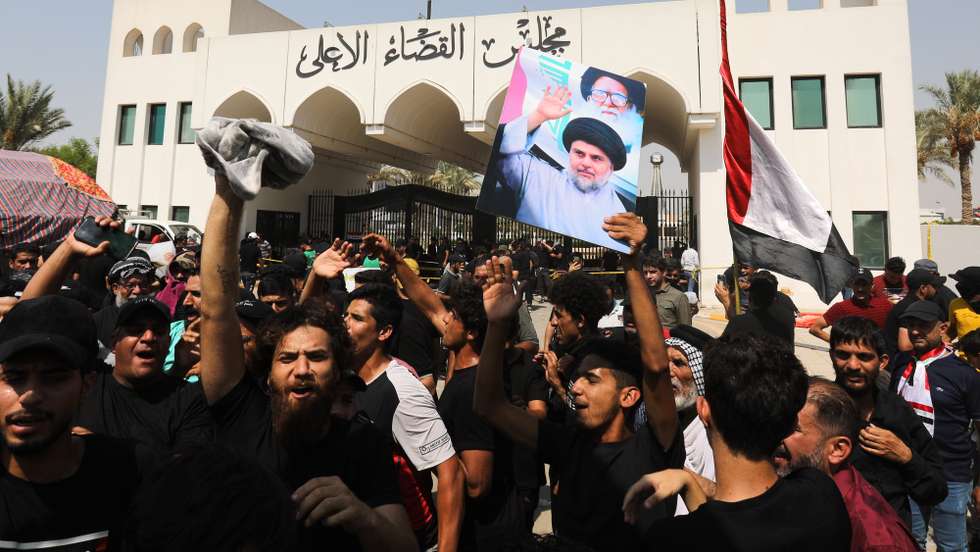 epaselect epa10134469 Supporters of Iraqi Shiite cleric Muqtada al-Sadr, head of the Sadrist movement carry his picture in front of the Supreme Judicial Council, Baghdad, Iraq, 23 August 2022. Supporters of Iraqi Shiite leader Muqtada al-Sadr gathered for a protest and sit-in in front of the Supreme Judicial Council demanding the dissolution of the parliament. They also continue a sit-in at the parliament that began on 30 July, while Supporters of the coordination framework gathered to protest against the rival Sadr's followers and calling for forming a new government after October legislative elections.  EPA/AHMED JALIL