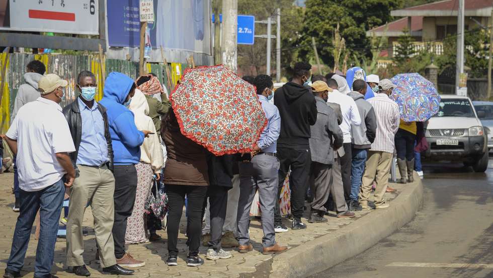 epa09290512 Ethiopians wait in line to cast their ballots in the presidential elections at a polling station in Addis Ababa, Ethiopia, 21 June 2021. Having been delayed twice, this is the sixth general elections in most regions of the country with some regions only voting on  06 September 2021. According to Birtukan Mideksa, the chairwoman of the National Electoral Board of Ethiopia (NEBE) Harar and Somali regions would only cast their ballots in September citing irregularities and problems with the printing of ballot papers.  EPA/STR