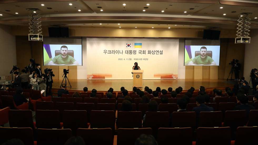 epa09884203 Ukrainian President Volodymyr Zelensky addresses the South Korean parliamentary via video link at the National Assembly in Seoul, South Korea, 11 April 2022. Zelensky has been making a virtual world tour in recent weeks, lobbying foreign governments by video to help Ukraine defend itself against Russia's invasion.  EPA/Chung Sung-Jun / POOL