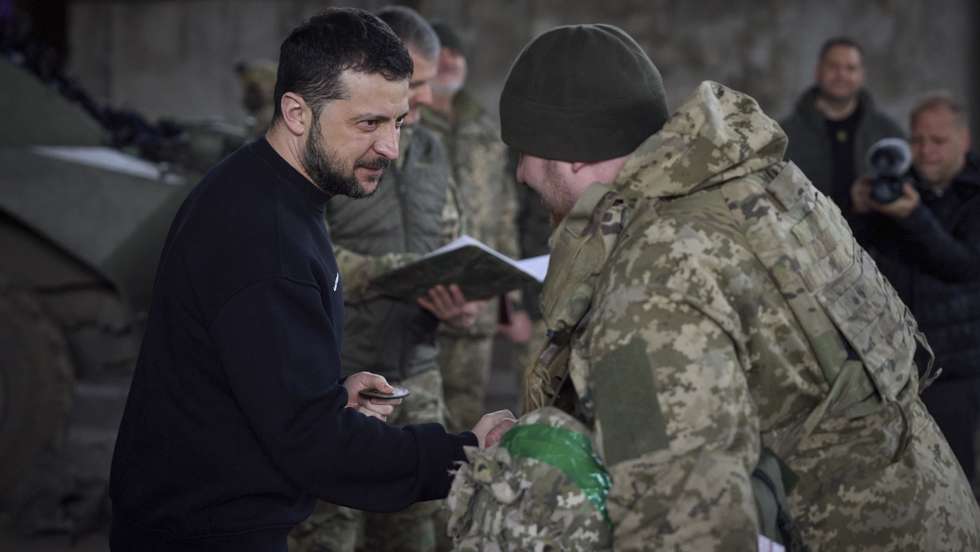 epa10536773 A handout photo made available by the Ukrainian Presidential Press Service shows Ukrainian President Volodymyr Zelensky (L) awarding a serviceman as he visits the advanced positions of the Ukrainian military in the Bakhmut direction, during a working trip to the Donetsk region, at an undisclosed location in Ukraine, 22 March 2023, amid the Russian invasion of the country. Russian troops entered Ukrainian territory on 24 February 2022, starting a conflict that has provoked destruction and a humanitarian crisis.  EPA/PRESIDENTIAL PRESS SERVICE HANDOUT  HANDOUT EDITORIAL USE ONLY/NO SALES