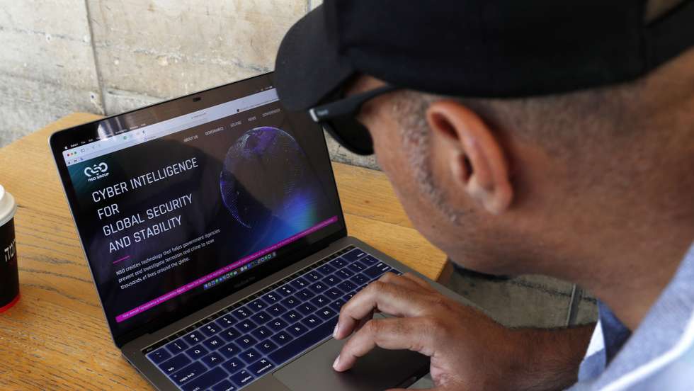 epa09924511 A man reads the website of NSO Group, an Israeli technology firm primarily known for its proprietary spyware Pegasus, in Jerusalem, Israel, 03 May 2022. Spanish officials say that the cell phones of the Spanish prime minister and the defense minister were infected with the Pegasus spyware in 2021.  EPA/ATEF SAFADI
