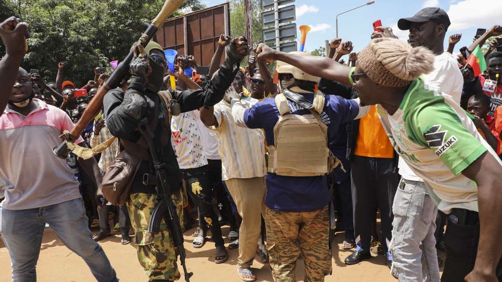 epa10219992 A man fist pumps with a soldier carrying a rocket propelled grenade (RPG) during a rally in support of the coup in Ouagadougou, Burkina Faso, 02 October 2022. Thousands of residents came out in support of the coup and protested against France and called for more involvement from Russia. On 01 October, gunshots were heard and the French embassy was set on fire a day after a coup in Ouagadougou. Burkina Faso military Colonel Ibrahim Traore announced on state television 30 September that he had seized power from Lt-Col Paul-Henri Damiba in the coup and alleged Damiba is plotting a counter-attack. In January 2022 Lt-Col Paul-Henri Damiba, ousted President Roch Kabore through a coup.  EPA/ASSANE OUEDRAOGO