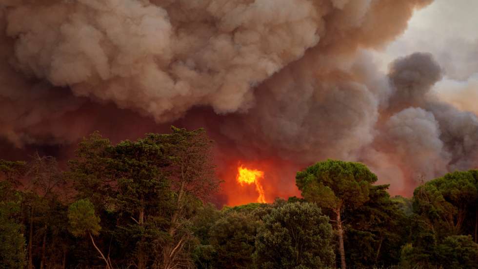 epa09358808 Smoke rises from the forest fire originated in Girona, Spain, 22 July 2021. The fire has so far burnt around 20 hectares with no residential areas affected.  EPA/DAVID BORRAT