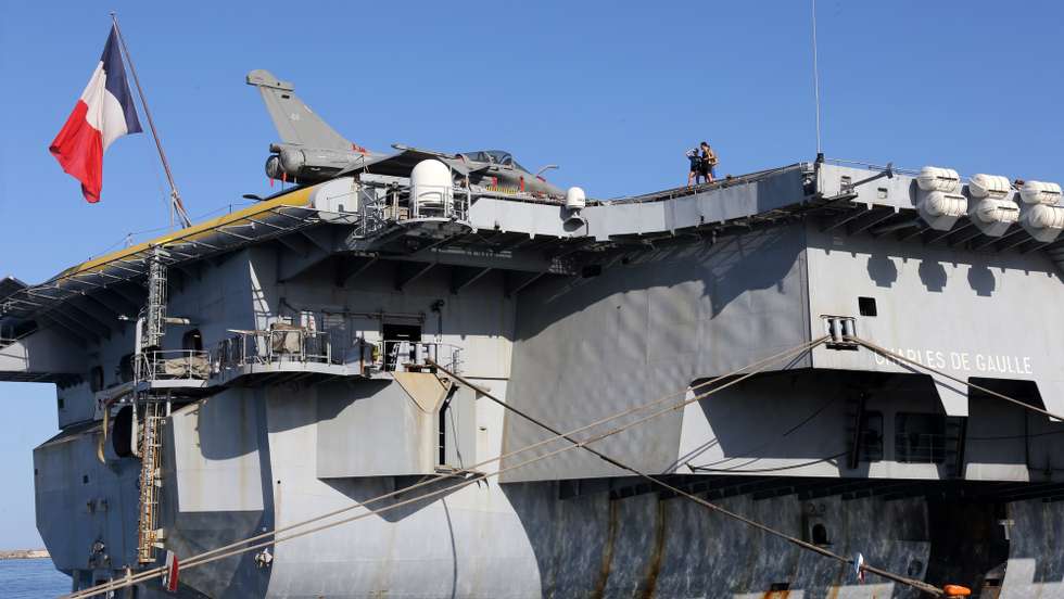 epa09189639 A view of the French aircraft carrier 'Charles de Gaulle' docked at the port of Limassol, Cyprus, 10 May 2021. France's nuclear aircraft carrier Charles de Gaulle makes a port call in Limassol for roughly a week as part of her mission 'Clemenceau 2021'. From February to June 2021, France deploys its carrier strike group (CSG), formed as Task Force 473, around the aircraft carrier Charles de Gaulle and its air wing. This naval force will be engaged in the eastern Mediterranean, in the Persian Gulf and in the Indian Ocean (Arabian Sea).  EPA/KATIA CHRISTODOULOU