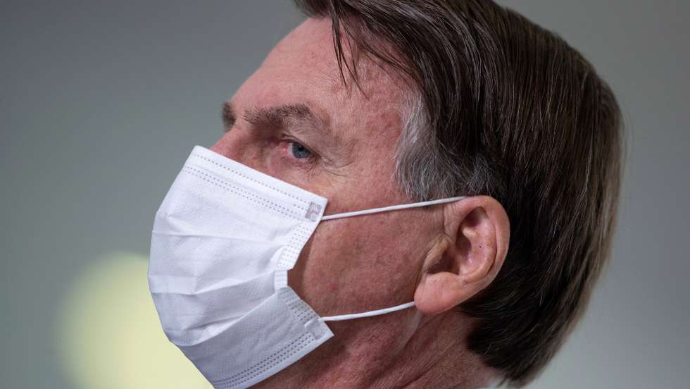 epa09108722 Brazilian President Jair Bolsonaro participates in a press conference at the Palacio do Planalto, in Brasilia, Brazil, 31 March 2021. Bolsonaro criticized the measures that seek to restrict the movement of the population in the face of the coronavirus pandemic and assured that &#039;hunger kills much more than the virus itself&#039;.  EPA/JOEDSON ALVES